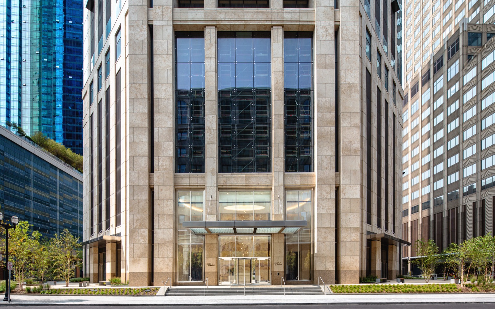 99 Hudson — 99 Hudson — street-level view of the limestone facade and residential entrance in Jersey City.